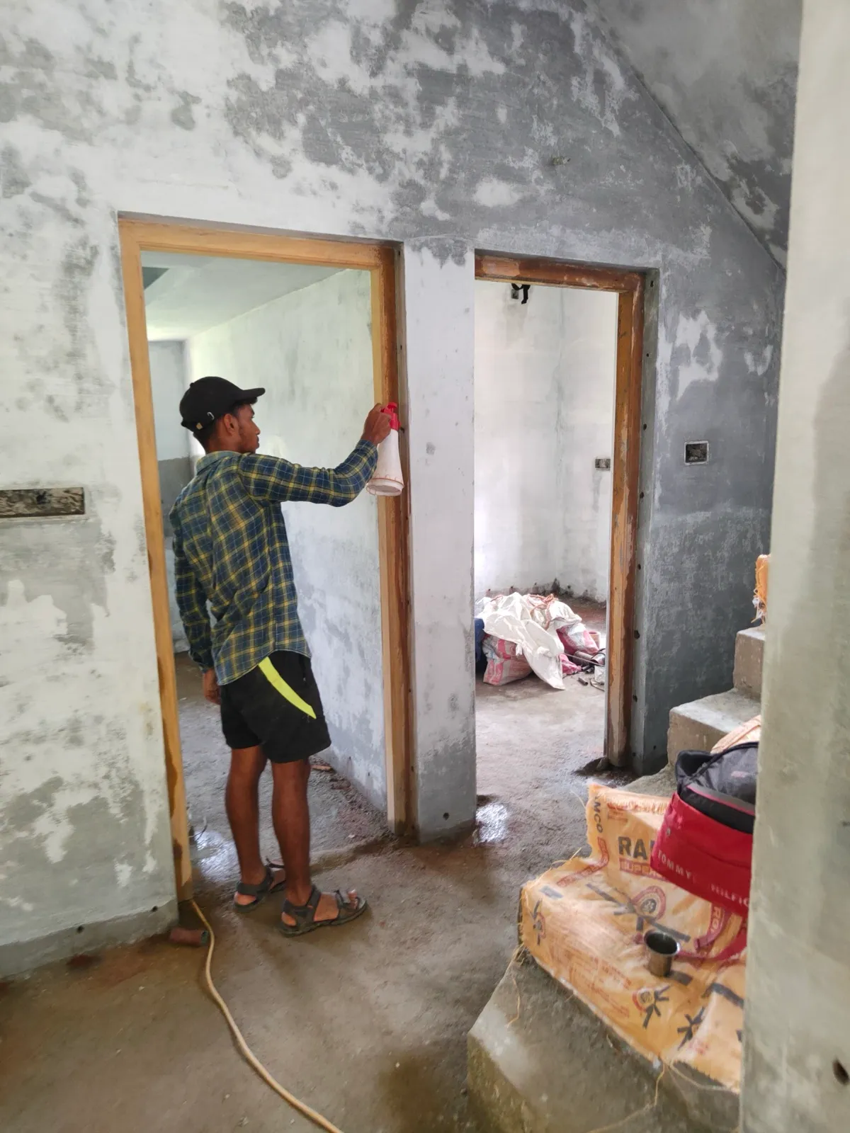 A Quality Pest Controls technician treating a wooden door frame